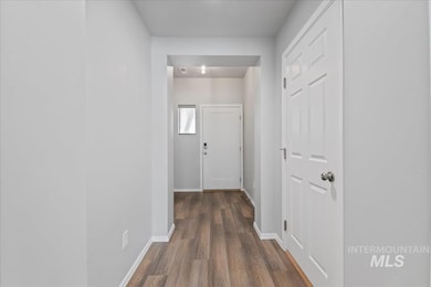 Corridor with baseboards and dark wood-type flooring