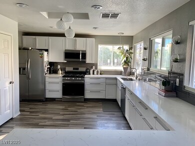 Kitchen with stainless steel appliances, a sink, h