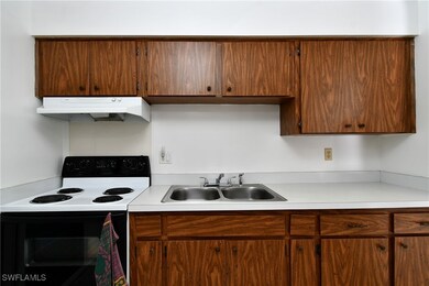 Kitchen featuring under cabinet range hood, electr