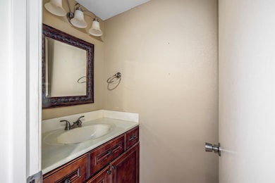 Convenient downstairs half bath with rich wood cab