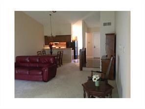 This spacious living room is enhanced with high ceilings.