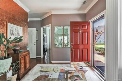 Foyer, Hardwood flooring, Kitchen opening on the r