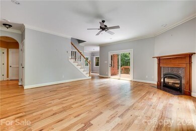 Living room with hardwoods and corner Fp with gas logs and  entry to back deck
