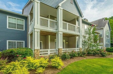 View of front facade with a porch and stone siding