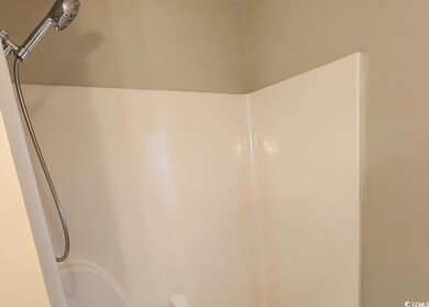 Bathroom view of washtub / shower combination