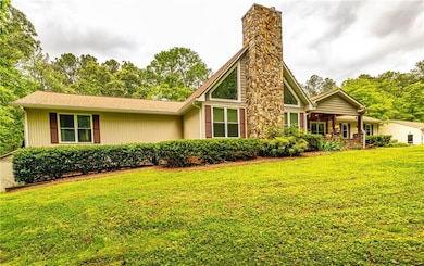 View of front facade with a front yard and a chimney
