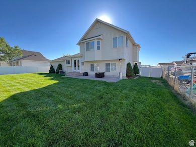 Rear view of property with a patio and a fenced backyard