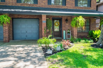 Doorway to property with brick siding, a porch, and concrete driveway