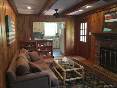 Friends & family gather in this spacious yet comfortable family room w/hardwood floor, beams, brick FP, new recessed lighting & door to patio & yard! Conveniently open to kitchen!