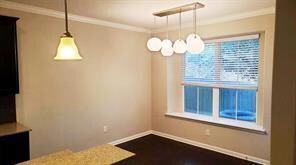 Unfurnished dining area with ornamental molding a