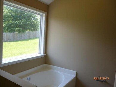 MASTER BEDROOM WHIRLPOOL TUB HAS LARGE WINDOW