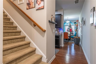 Staircase featuring hardwood / wood-style floors