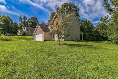 View of property exterior with a yard