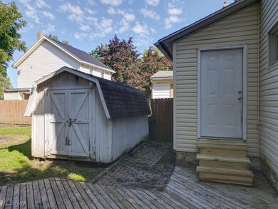 View of shed and back entry to home featuring entry steps