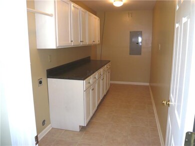 Huge laundry room with loads of cabinets and count