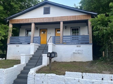Bungalow-style home featuring stairway and covered