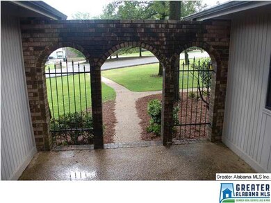 Arched walkways to entrance of house.