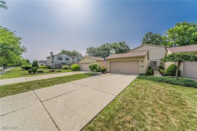 View of front facade featuring a garage and a front lawn