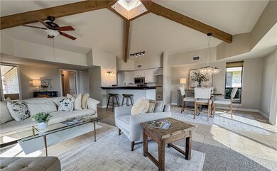 Living room featuring vaulted ceilings, open floor