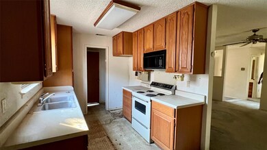 Kitchen with a textured ceiling, white electric st