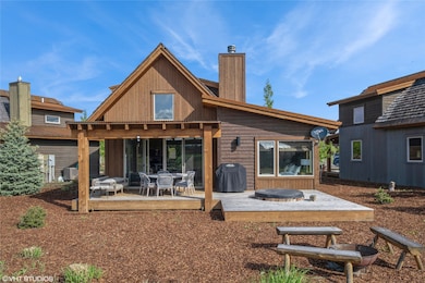 Rear view of house with a chimney and a patio