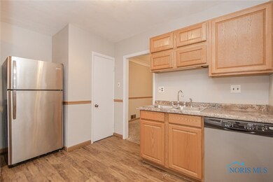 Updated kitchen features plank laminate flooring a
