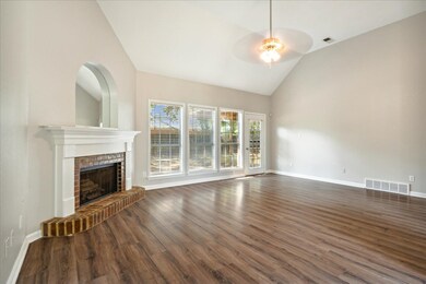Unfurnished living room with ceiling fan, high vau