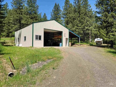 Garage featuring a detached garage and driveway