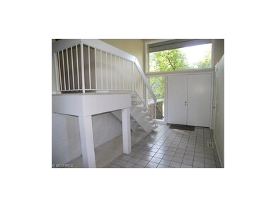 The foyer features a tile floor and natural light