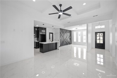 Foyer entrance with marble finish floor, coffered ceiling, visible vents, and baseboards