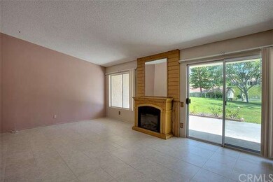 Main living room with fireplace and views to green