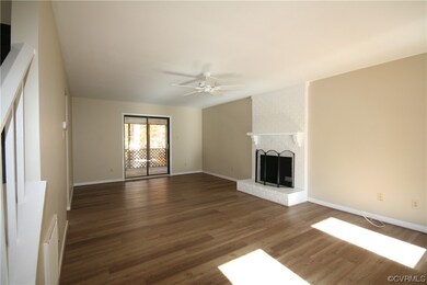 Living room featuring a fireplace, brick wall, lig