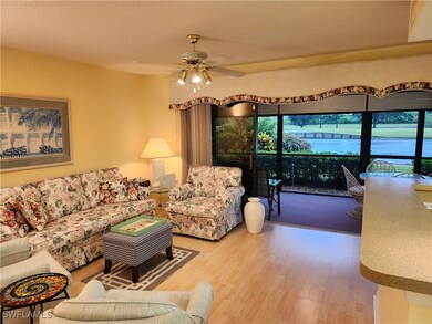 Living room with ceiling fan, a water view, and ha