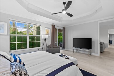 Bedroom with ceiling fan, ornamental molding, a ra
