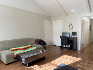 Living room with wood finished floors and an offi