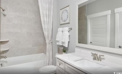 Full bathroom featuring shower / bath combo with shower curtain and vanity