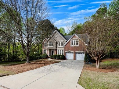 View of front of home featuring driveway, brick si