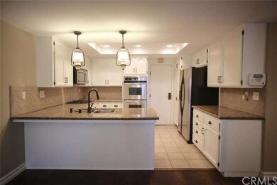 The updated kitchen features granite counters, dec