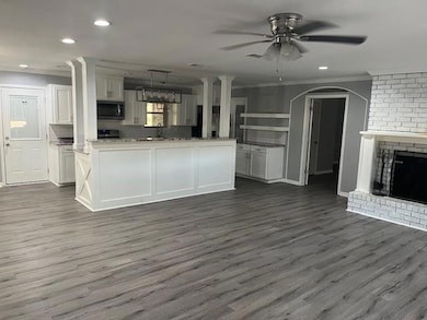 Kitchen featuring dark wood-type flooring, hanging