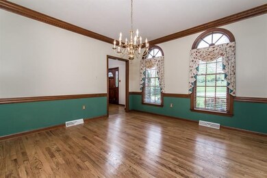 Formal Dining Room with hardwood flooring, crown m