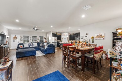 Dining room with wood tiled floors, recessed lighting, and a ceiling fan