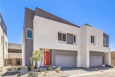 Modern home with a garage, stucco siding, and driveway