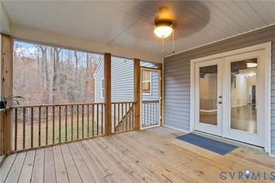 Unfurnished sunroom featuring a deck and french doors