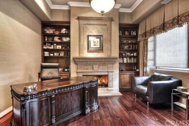 Hardwood floors, fabric walls and tasteful firepla