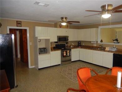 The kitchen is lots of cabinets gas range over the