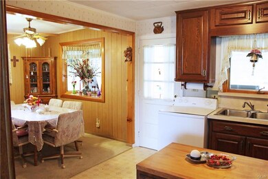 Kitchen and dining rooms with door to 4 season roo