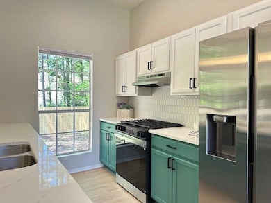 Kitchen featuring stainless steel fridge with ice 