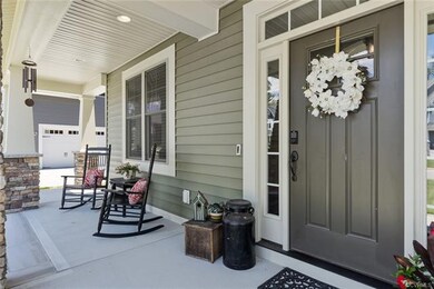 Welcoming front porch with plenty of room for neig