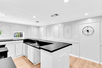 Living area with a ceiling fan, visible vents, lig