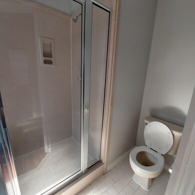 Bathroom with tile patterned floors, toilet, and a